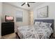 Comfortable bedroom with bed, dresser, TV and neutral colors at 4512 S Ferric Ave, Mesa, AZ 85212