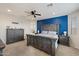 Primary bedroom featuring a blue accent wall, ceiling fan and elegant furnishings at 4512 S Ferric Ave, Mesa, AZ 85212