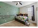 Cozy bedroom featuring a bed, shelving, a ceiling fan and playful accents at 4512 S Ferric Ave, Mesa, AZ 85212