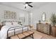 This bedroom features a large bed, a dresser with decor, and a window letting in lots of natural light at 4512 S Ferric Ave, Mesa, AZ 85212