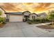 Charming one-story home with a two car garage, stone accents, and manicured landscaping at 4512 S Ferric Ave, Mesa, AZ 85212