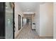 Inviting hallway with light wood-look tile floors and crisp white shiplap walls, leading to the home's interior at 4512 S Ferric Ave, Mesa, AZ 85212