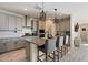 Stylish kitchen with a center island, pendant lighting, and light gray cabinetry at 4512 S Ferric Ave, Mesa, AZ 85212