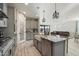 Open-concept kitchen with island and farm sink flowing to the dining and living area at 4512 S Ferric Ave, Mesa, AZ 85212