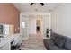 Home office featuring a desk, couch, and double doors leading to the hallway at 4512 S Ferric Ave, Mesa, AZ 85212
