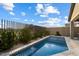 The property features a fenced pool surrounded by rocks, grass, and landscaping at 4512 S Ferric Ave, Mesa, AZ 85212