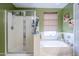 Well-lit bathroom features a soaking tub and separate shower, creating a spa-like retreat at 45543 W Guilder Ave, Maricopa, AZ 85139