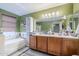Bright bathroom with double sink vanity and a relaxing soaking tub, blending style and functionality at 45543 W Guilder Ave, Maricopa, AZ 85139