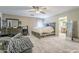Spacious bedroom featuring a ceiling fan and ensuite bathroom, offers a comfortable and inviting space to relax at 45543 W Guilder Ave, Maricopa, AZ 85139