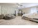 Bright bedroom featuring a ceiling fan, offers a comfortable and inviting space to relax at 45543 W Guilder Ave, Maricopa, AZ 85139