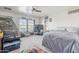 This bedroom offers a ceiling fan, a large window, and carpeted floors at 45543 W Guilder Ave, Maricopa, AZ 85139