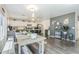 Bright dining area and kitchen with modern appliances, lighting, and decor at 45543 W Guilder Ave, Maricopa, AZ 85139
