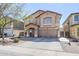 Charming two-story home featuring a spacious driveway, covered porch, and low-maintenance front yard at 45543 W Guilder Ave, Maricopa, AZ 85139