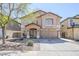 Charming two-story home featuring a spacious driveway, covered porch, and low-maintenance front yard at 45543 W Guilder Ave, Maricopa, AZ 85139