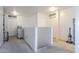 Bright hallway with neutral carpet and white walls offers a clean, open transition between spaces at 45543 W Guilder Ave, Maricopa, AZ 85139