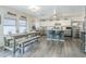 Modern kitchen boasts granite countertops, stainless steel appliances, and breakfast bar seating at 45543 W Guilder Ave, Maricopa, AZ 85139