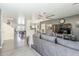 Open-concept living area with views to a pool table and comfortable sectional seating at 45543 W Guilder Ave, Maricopa, AZ 85139