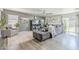 Inviting living room with modern decor, comfortable seating, a ceiling fan, and sliding glass doors for outdoor access at 45543 W Guilder Ave, Maricopa, AZ 85139