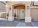 Close-up of the porch with stylish seating, decorative lighting, and a secure front door at 45543 W Guilder Ave, Maricopa, AZ 85139