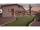 Backyard featuring a putting green, built-in grill, and desert landscaping, under a vibrant sunset at 4615 S Primrose Dr, Gold Canyon, AZ 85118