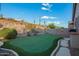 Private backyard with a putting green, desert landscaping and mountain views, perfect for outdoor recreation at 4615 S Primrose Dr, Gold Canyon, AZ 85118