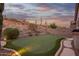 Private backyard with a putting green, desert landscaping and mountain views, perfect for outdoor recreation at 4615 S Primrose Dr, Gold Canyon, AZ 85118