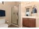 Bathroom featuring neutral walls, a glass shower, a toilet, and a stylish vanity with a mirror at 4615 S Primrose Dr, Gold Canyon, AZ 85118