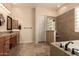 Serene bathroom featuring a separate soaking tub, glass block shower and double vanity with a dressing table at 4615 S Primrose Dr, Gold Canyon, AZ 85118