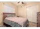 Neutral bedroom features a queen bed with stylish bedding, a ceiling fan, and mirrored closet doors at 4615 S Primrose Dr, Gold Canyon, AZ 85118