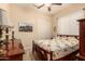Bedroom with a ceiling fan, a large bed with quilt, and sliding closet doors at 4615 S Primrose Dr, Gold Canyon, AZ 85118