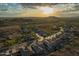 Panoramic aerial shot of a desert community under a stunning sunset at 4615 S Primrose Dr, Gold Canyon, AZ 85118