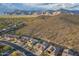 Aerial view of homes in a desert community, set against a mountain range at 4615 S Primrose Dr, Gold Canyon, AZ 85118