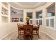 Charming breakfast nook with a round wooden table, seating for four, and natural light from large windows at 4615 S Primrose Dr, Gold Canyon, AZ 85118