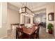 Inviting dining room with a stylish chandelier, tray ceiling, and access to the living room at 4615 S Primrose Dr, Gold Canyon, AZ 85118