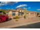 Charming single-story home featuring desert landscaping, a tile roof, and a three-car garage at 4615 S Primrose Dr, Gold Canyon, AZ 85118