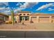 Beautiful beige home with a tile roof, 2-car garage, desert landscaping, and stone accents on the facade at 4615 S Primrose Dr, Gold Canyon, AZ 85118