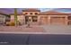 Beautiful beige home with a tile roof, 2-car garage, desert landscaping, and stone accents on the facade at 4615 S Primrose Dr, Gold Canyon, AZ 85118