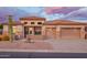 Beautiful beige home with a tile roof, 2-car garage, desert landscaping, and stone accents on the facade at 4615 S Primrose Dr, Gold Canyon, AZ 85118