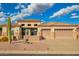 Beautiful beige home with a tile roof, 2-car garage, desert landscaping, and stone accents on the facade at 4615 S Primrose Dr, Gold Canyon, AZ 85118