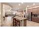 Open-concept kitchen featuring granite countertops, a central island with barstool seating, and stainless steel appliances at 4615 S Primrose Dr, Gold Canyon, AZ 85118