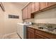 Laundry room featuring a sink, granite countertops, and a modern washer and dryer at 4615 S Primrose Dr, Gold Canyon, AZ 85118