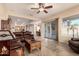 Spacious living room with tile flooring, ceiling fan, sliding glass doors, and easy kitchen access at 4615 S Primrose Dr, Gold Canyon, AZ 85118