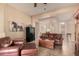 Cozy living room boasts tile floors, comfortable leather furniture, and plenty of natural light at 4615 S Primrose Dr, Gold Canyon, AZ 85118