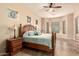 Relaxing main bedroom with ceiling fan, stained-glass windows and a plush, wooden bed frame at 4615 S Primrose Dr, Gold Canyon, AZ 85118