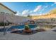 Backyard pool with rock waterfall feature and lush desert landscaping at 4615 S Primrose Dr, Gold Canyon, AZ 85118