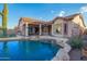 Stunning backyard pool with rock waterfall feature, covered patio, and desert plants at 4615 S Primrose Dr, Gold Canyon, AZ 85118
