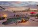 Backyard retreat featuring a pool with desert landscaping, waterfall feature, and a relaxing poolside environment at 4615 S Primrose Dr, Gold Canyon, AZ 85118