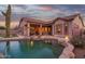 Backyard with a swimming pool, putting green, built-in grill, desert landscaping, and covered patio at 4615 S Primrose Dr, Gold Canyon, AZ 85118