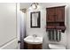 Bathroom with a dark wood vanity, mirror, and shower with curtain at 5137 N 20Th Ave, Phoenix, AZ 85015