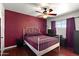 Comfortable bedroom featuring a red wall, hardwood floors, and lots of natural light at 5137 N 20Th Ave, Phoenix, AZ 85015